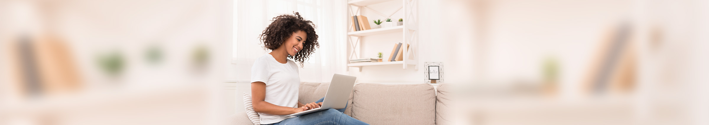 Woman sitting on couch with laptop