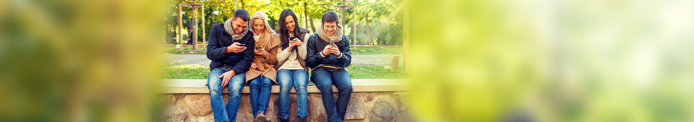 Group of young people on cellphones outside