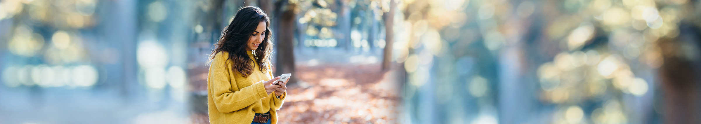 Woman on cellphone in forest