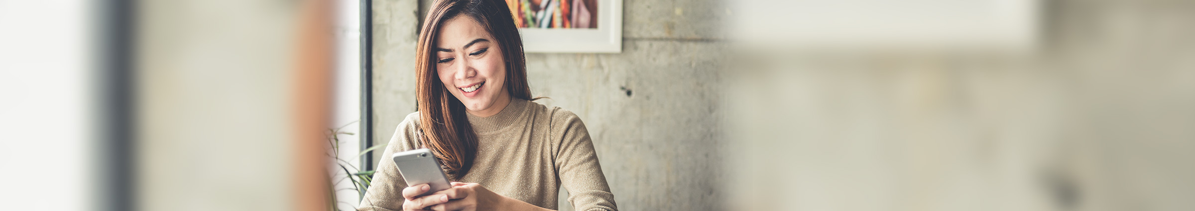 Young woman on cellphone at cafe