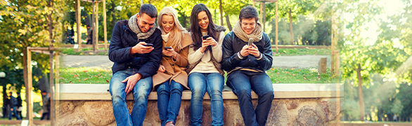 Group of young people on cellphones outside