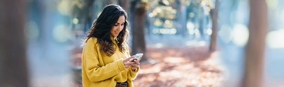 Woman on cellphone in forest