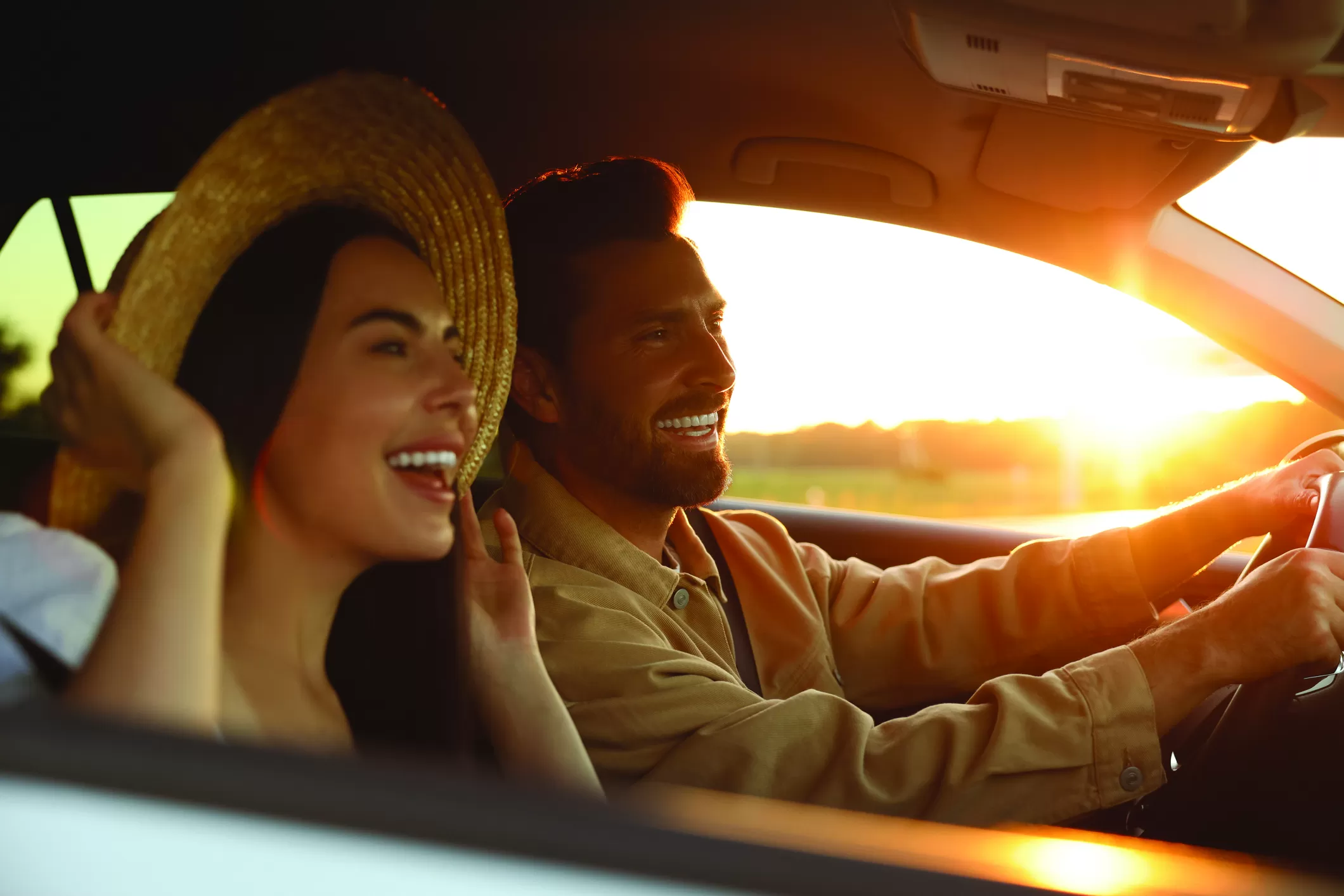 couple driving in sunset