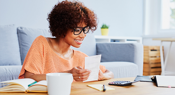 Woman looking at calculator