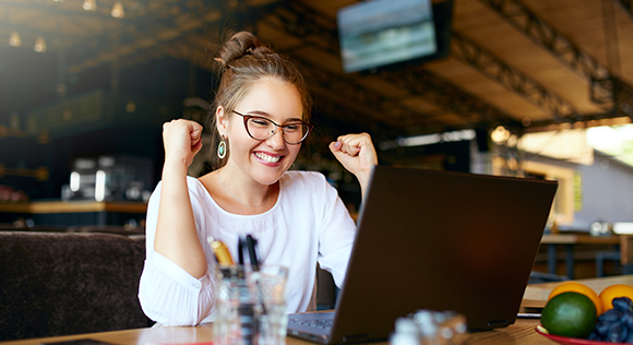 Woman smiling looking at computer