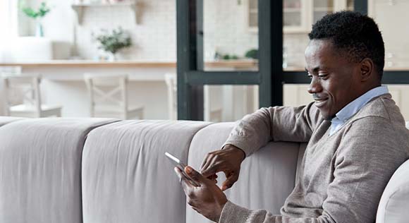 Man in mask looking at tablet